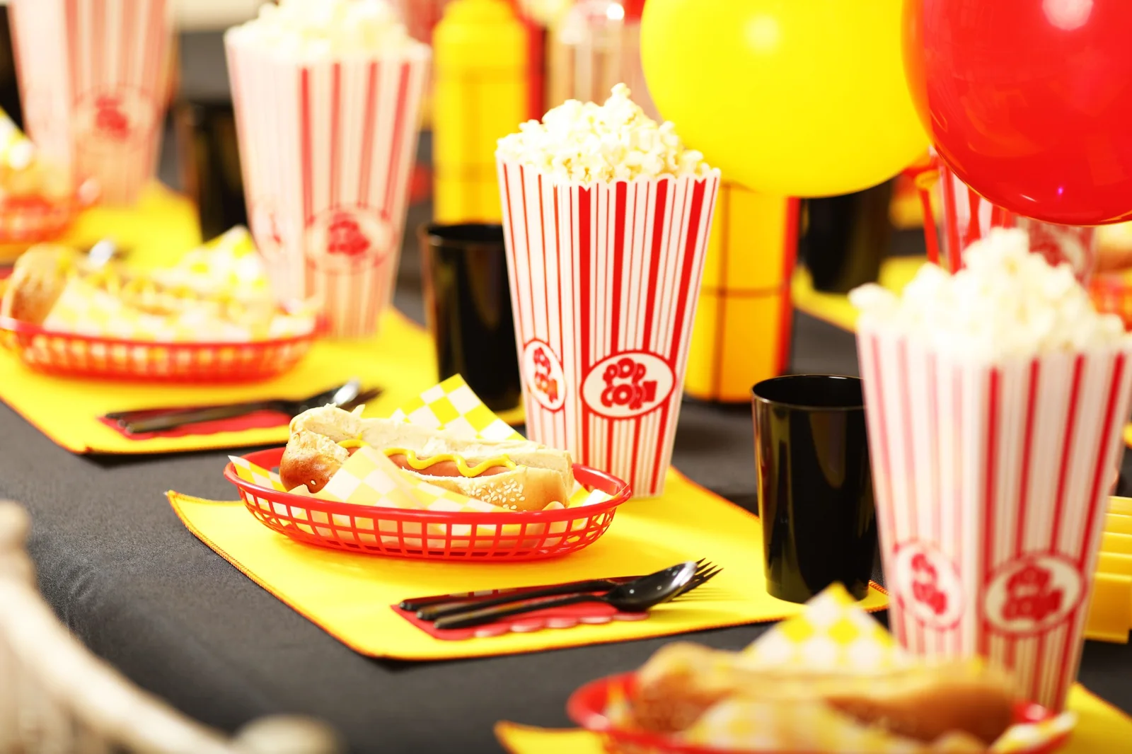 Colourful cinema themed party table with popcorn