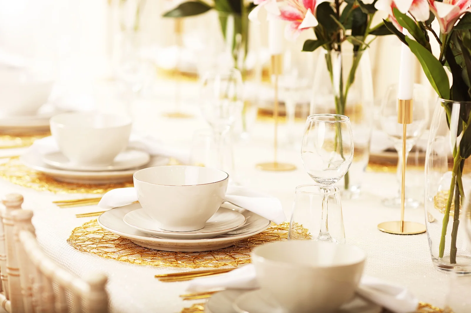 Elegant white and gold table setting with flowers